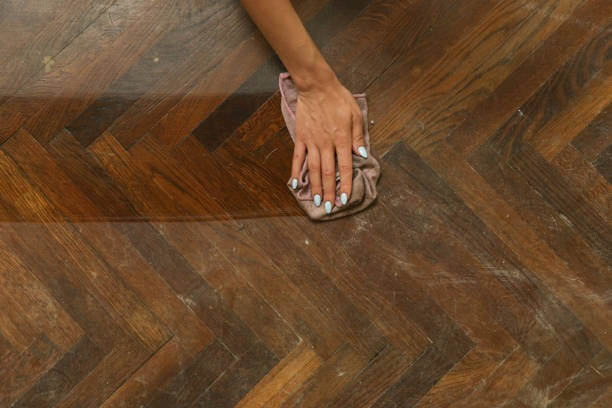 moping parquet with a piece of clothes